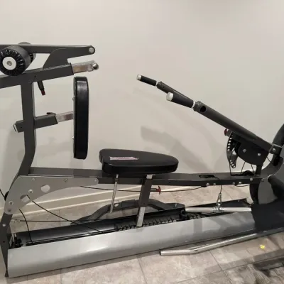 Sale Photo Thumbnail #19: Multi-station home gym weight machine featuring a steel frame, padded black vinyl seat and backrest, and integrated cable pulley system.