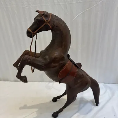 Sale Photo Thumbnail #48: Vintage leather-wrapped rearing horse figurine, featuring detailed leather tack including a saddle and bridle.