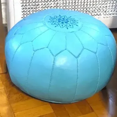 Sale Photo Thumbnail #37: Bright blue Moroccan leather pouf ottoman featuring embroidered medallion detailing and stitched paneled construction.