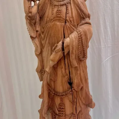 Sale Photo Thumbnail #44: Hand-carved wooden statue of Guanyin standing on a lotus base, featuring intricate drapery details and a prominent vertical crack running down the front.