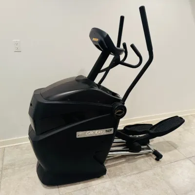 Sale Photo Thumbnail #21: Octane Fitness standing elliptical machine in a modern black finish, featuring moving handlebars and integrated console.