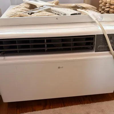 Sale Photo Thumbnail #59: LG modern white window air conditioner unit with digital display and mounting hardware.
