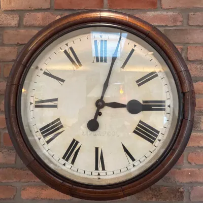 Sale Photo Thumbnail #54: Large vintage wall clock with a wooden frame and Roman numerals, marked Liverpool on the dial.