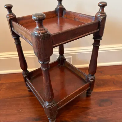 Sale Photo Thumbnail #46: Antique dark-stained wooden two-tier plant stand or accent table featuring turned corner posts with finials and gallery-style edges.