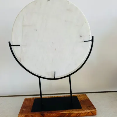 Sale Photo Thumbnail #24: Modern circular white stone or marble disc sculpture mounted on a black metal frame and rustic wood base.