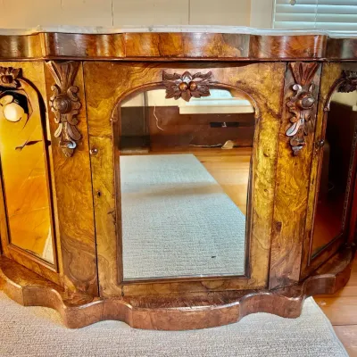 Sale Photo Thumbnail #49: Antique Victorian burl walnut credenza with marble top, carved floral accents, and mirrored door panels.