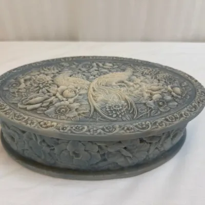 Sale Photo Thumbnail #43: Vintage carved oval stone trinket box featuring a detailed high-relief design of peacocks and floral motifs.