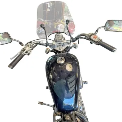 Top-down view of a cruiser motorcycle featuring handlebars, dual side mirrors, a clear windshield, and a glossy dark fuel tank.