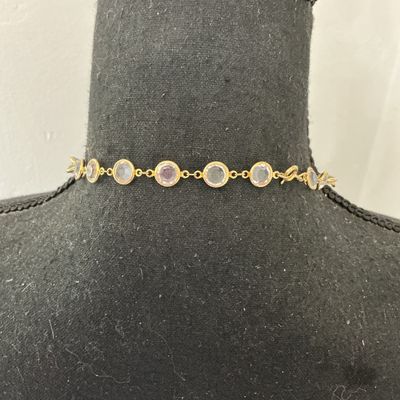 Sale Photo Thumbnail #79: Gold-tone chain station necklace featuring bezel-set round clear facetted crystals or glass stones. Secured with a spring ring clasp. In good pre-owned condition with minor signs of wear.
