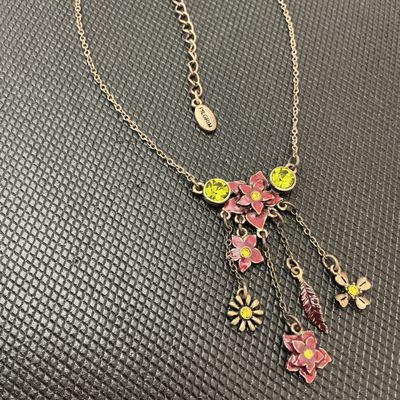 Sale Photo Thumbnail #99: Pilgrim Danish Design necklace featuring an antiqued brass-tone finish with enameled pink floral motifs, leaf charm, and yellow/green crystal rhinestone accents. Includes an adjustable extender chain with a 'Danish Design' hang tag and a stamped 'Pilgrim'