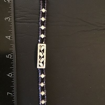 Sale Photo Thumbnail #88: Silver-tone tennis/link style bracelet featuring purple faceted crystal or glass beads, clear rhinestone square accents, and a central rectangular filigree panel set with marquise-cut rhinestones. Secured with a lobster claw clasp. Measures approximately 
