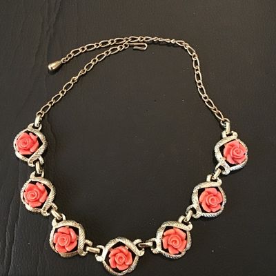 Sale Photo Thumbnail #37: Vintage Sarah Coventry gold-tone chain necklace featuring links set with carved or molded coral-pink resin roses within textured framed borders. Features a hook clasp and adjustable extender chain. Good vintage condition with light, expected age-related w
