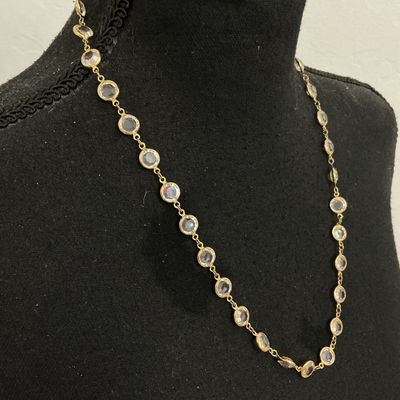 Sale Photo Thumbnail #72: Gold-tone chain station necklace featuring bezel-set round clear facetted crystals or glass stones. Secured with a spring ring clasp. In good pre-owned condition with minor signs of wear.