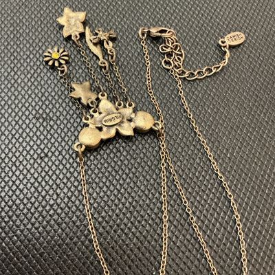 Sale Photo Thumbnail #102: Pilgrim Danish Design necklace featuring an antiqued brass-tone finish with enameled pink floral motifs, leaf charm, and yellow/green crystal rhinestone accents. Includes an adjustable extender chain with a 'Danish Design' hang tag and a stamped 'Pilgrim'