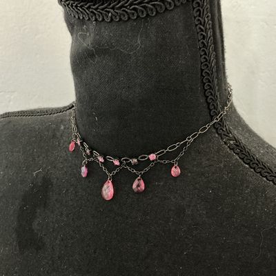 Sale Photo Thumbnail #120: A gothic-style dark gunmetal tone choker necklace featuring a layered chain design adorned with round pink rhinestone accents and faceted pink teardrop glass/crystal dangling beads. Includes an adjustable extension chain with a lobster claw clasp. Appears