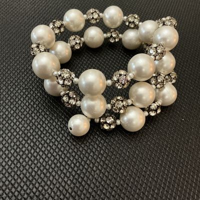 Sale Photo Thumbnail #115: A stylish costume jewelry coil/wrap bracelet featuring large luminous faux pearl beads interspersed with sparkly pave rhinestone spacer balls. Flexible memory wire design fits most wrist sizes comfortably. Good condition with all stones intact and minor s