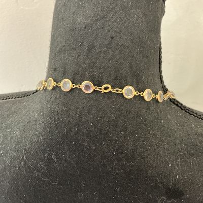 Sale Photo Thumbnail #81: Gold-tone chain station necklace featuring bezel-set round clear facetted crystals or glass stones. Secured with a spring ring clasp. In good pre-owned condition with minor signs of wear.