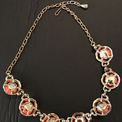 Sale Photo Thumbnail #41: Vintage Sarah Coventry gold-tone chain necklace featuring links set with carved or molded coral-pink resin roses within textured framed borders. Features a hook clasp and adjustable extender chain. Good vintage condition with light, expected age-related w
