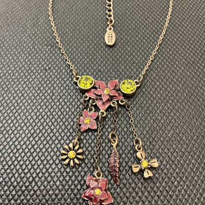Sale Photo Thumbnail #93: Pilgrim Danish Design necklace featuring an antiqued brass-tone finish with enameled pink floral motifs, leaf charm, and yellow/green crystal rhinestone accents. Includes an adjustable extender chain with a 'Danish Design' hang tag and a stamped 'Pilgrim'
