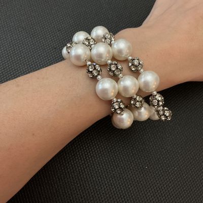 Sale Photo Thumbnail #118: A stylish costume jewelry coil/wrap bracelet featuring large luminous faux pearl beads interspersed with sparkly pave rhinestone spacer balls. Flexible memory wire design fits most wrist sizes comfortably. Good condition with all stones intact and minor s