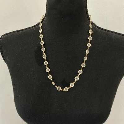 Sale Photo Thumbnail #68: Gold-tone chain station necklace featuring bezel-set round clear facetted crystals or glass stones. Secured with a spring ring clasp. In good pre-owned condition with minor signs of wear.
