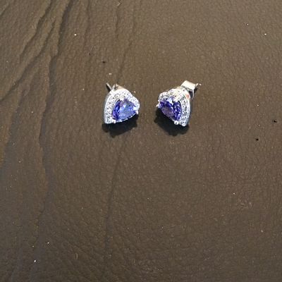Sale Photo Thumbnail #213: Pair of silver-tone stud earrings featuring heart-cut purple central stones surrounded by halo borders of clear accent stones. Secured with post backs. Good overall condition.