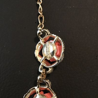 Sale Photo Thumbnail #45: Vintage Sarah Coventry gold-tone chain necklace featuring links set with carved or molded coral-pink resin roses within textured framed borders. Features a hook clasp and adjustable extender chain. Good vintage condition with light, expected age-related w