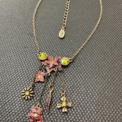 Sale Photo Thumbnail #96: Pilgrim Danish Design necklace featuring an antiqued brass-tone finish with enameled pink floral motifs, leaf charm, and yellow/green crystal rhinestone accents. Includes an adjustable extender chain with a 'Danish Design' hang tag and a stamped 'Pilgrim'