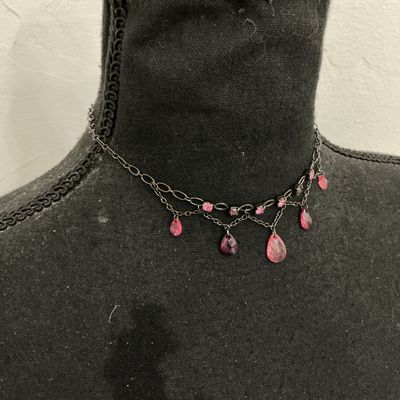 Sale Photo Thumbnail #123: A gothic-style dark gunmetal tone choker necklace featuring a layered chain design adorned with round pink rhinestone accents and faceted pink teardrop glass/crystal dangling beads. Includes an adjustable extension chain with a lobster claw clasp. Appears