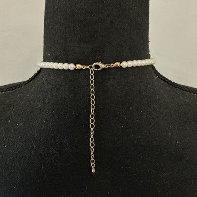Sale Photo Thumbnail #218: Faux pearl strand necklace featuring a gold-tone, scroll-embossed heart locket attached by a front toggle clasp. The heart locket opens to hold a small photo. The back features a lobster claw clasp with an adjustable extender chain. Good overall condition