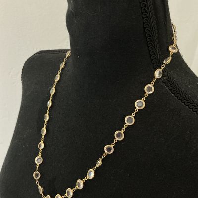 Sale Photo Thumbnail #76: Gold-tone chain station necklace featuring bezel-set round clear facetted crystals or glass stones. Secured with a spring ring clasp. In good pre-owned condition with minor signs of wear.