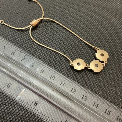 Sale Photo Thumbnail #162: Gold-tone adjustable slider/bolo style bracelet featuring three flower-shaped central stations set with clear faceted rhinestones and surrounded by smaller crystal accents. The adjustable slider bead allows for a customizable fit. Three main decorative el
