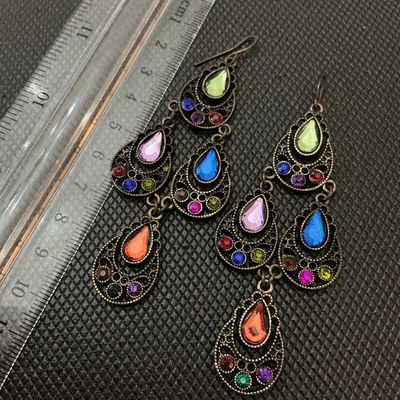 Sale Photo Thumbnail #152: Pair of antique gold-tone brass chandelier drop earrings set with colorful teardrop and round rhinestones in shades of green, pink, blue, orange, purple, and red. Features French hook ear wires. Measure approximately 3.5 inches (9 cm) in length. Good cond
