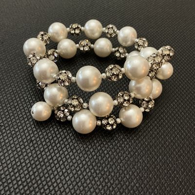 Sale Photo Thumbnail #112: A stylish costume jewelry coil/wrap bracelet featuring large luminous faux pearl beads interspersed with sparkly pave rhinestone spacer balls. Flexible memory wire design fits most wrist sizes comfortably. Good condition with all stones intact and minor s