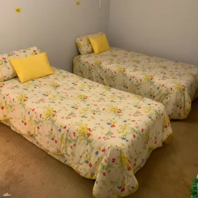 Set of 2 Twin Beds with Floral Bedding & Rolling Metal Frames