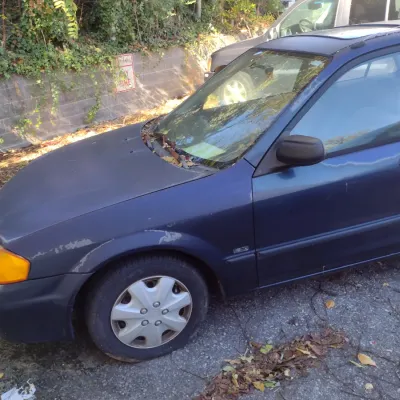 Sale Photo Thumbnail #42: 1999 Mazda Protege This is a cash, cashier's check or wire transfer purchase only.  Sold as is with no warranty or guarantees.  Vehicle has obvious exterior paint issues with some minor damage to rear and front bumpers and side panels.  Interior will need