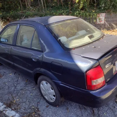 Sale Photo Thumbnail #41: 1999 Mazda Protege This is a cash, cashier's check or wire transfer purchase only.  Sold as is with no warranty or guarantees.  Vehicle has obvious exterior paint issues with some minor damage to rear and front bumpers and side panels.  Interior will need