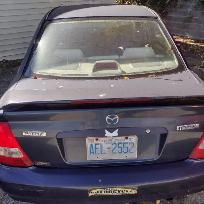 Sale Photo Thumbnail #49: 1999 Mazda Protege This is a cash, cashier's check or wire transfer purchase only.  Sold as is with no warranty or guarantees.  Vehicle has obvious exterior paint issues with some minor damage to rear and front bumpers and side panels.  Interior will need