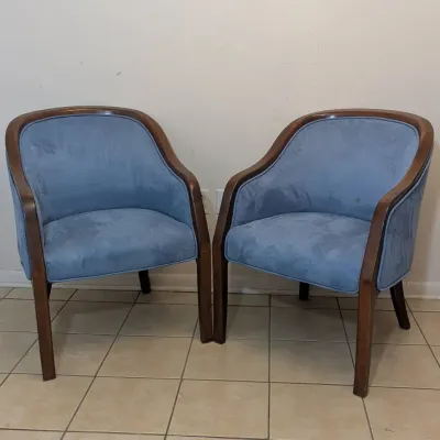 Sale Photo Thumbnail #36: Pair of mid-century barrel armchairs featuring light blue upholstery framed in polished dark wood.