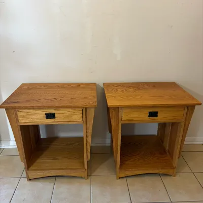 Sale Photo Thumbnail #52: Pair of oak end tables featuring a single top drawer with dark metal hardware and an open lower shelf.