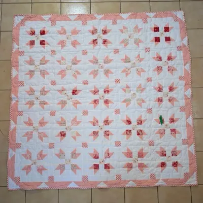 Sale Photo Thumbnail #15: Handmade patchwork star quilt featuring pink, red, and cream floral and gingham fabrics with a scalloped border.