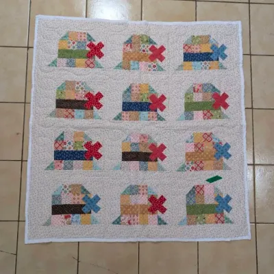 Sale Photo Thumbnail #21: Handmade patchwork quilt featuring 12 traditional Dutch windmill pattern blocks in a subtle floral fabric background.