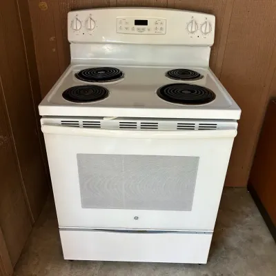 Sale Photo Thumbnail #55: White GE freestanding electric range with a coil cooktop and digital clock display panel.