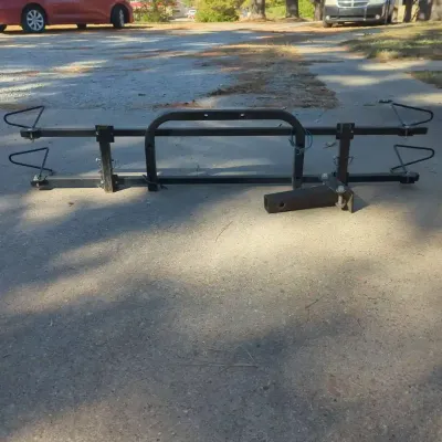Sale Photo Thumbnail #61: Black metal hitch-mounted tray-style bicycle rack, designed for transport on vehicle receiver hitches.