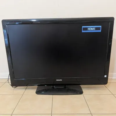 Sale Photo Thumbnail #58: Black Philips flat screen television on a matching base, shown powered on display with input menu.
