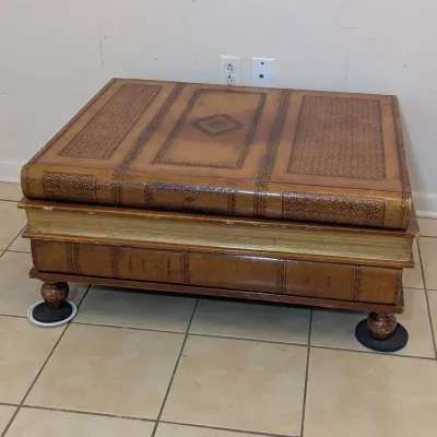 Sale Photo Thumbnail #34: Novelty stack-of-books coffee table featuring embossed leather-look trim and turned bun feet.