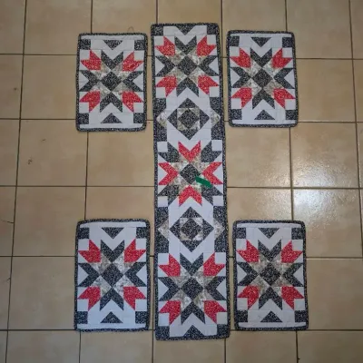 Sale Photo Thumbnail #29: Handmade quilted table runner and matching set of four placemats featuring a red, black, and white starburst pattern.