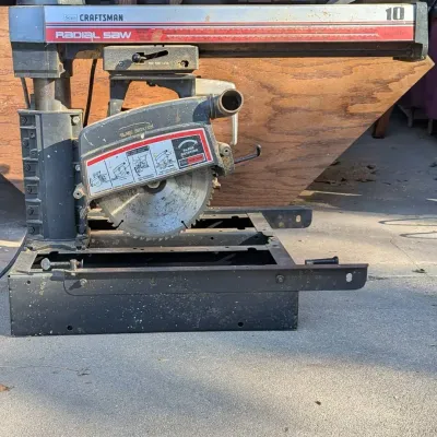 Sale Photo Thumbnail #59: Vintage Sears Craftsman 10-inch radial arm saw with black metal frame and blade guard assembly, showing light cosmetic wear.