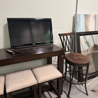 Sale Photo Thumbnail #81: Bar top table with usb plugs, stools mirrors, signs, TV.