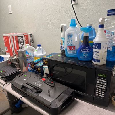 Sale Photo Thumbnail #84: Microwave, pots and pans, cleaning supplies and Vacuum sealer.